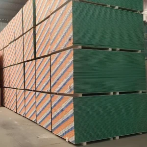 Large stacks of drywall pallets stored in a warehouse with alternating green and branded patterns.